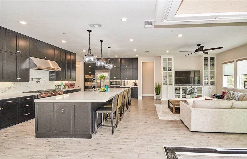 115 Crossover Irvine, CA 92618 - Photo 18 of 64 a large white kitchen with a large counter top and stainless steel appliances