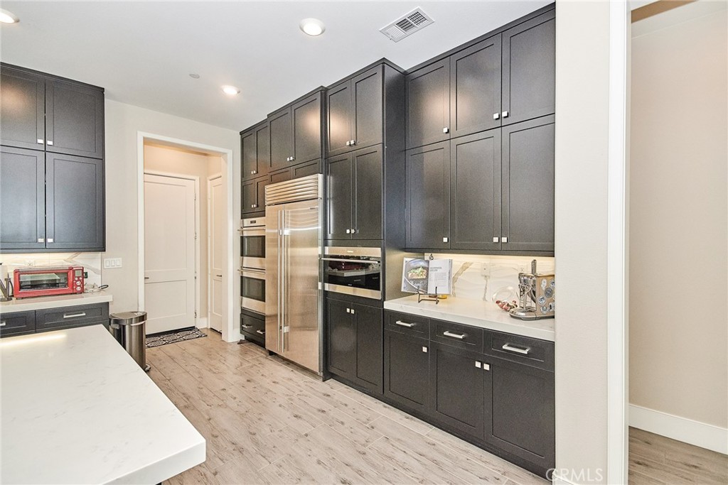 115 Crossover Irvine, CA 92618 - Photo 19 of 64 a kitchen with a refrigerator and a sink