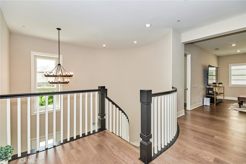 115 Crossover Irvine, CA 92618 - Photo 32 of 64 a view of a hallway with wooden floor and stairs