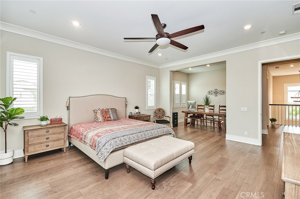 115 Crossover Irvine, CA 92618 - Photo 36 of 64 a bedroom with a bed and a chandelier