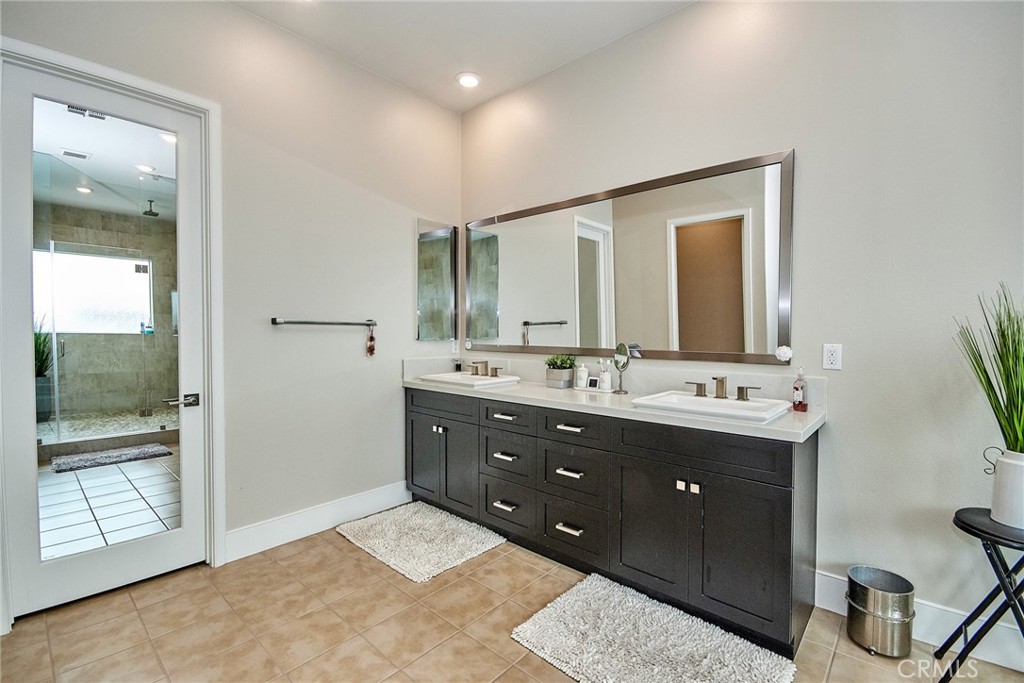 115 Crossover Irvine, CA 92618 - Photo 41 of 64 a bathroom with a double vanity sink and a mirror