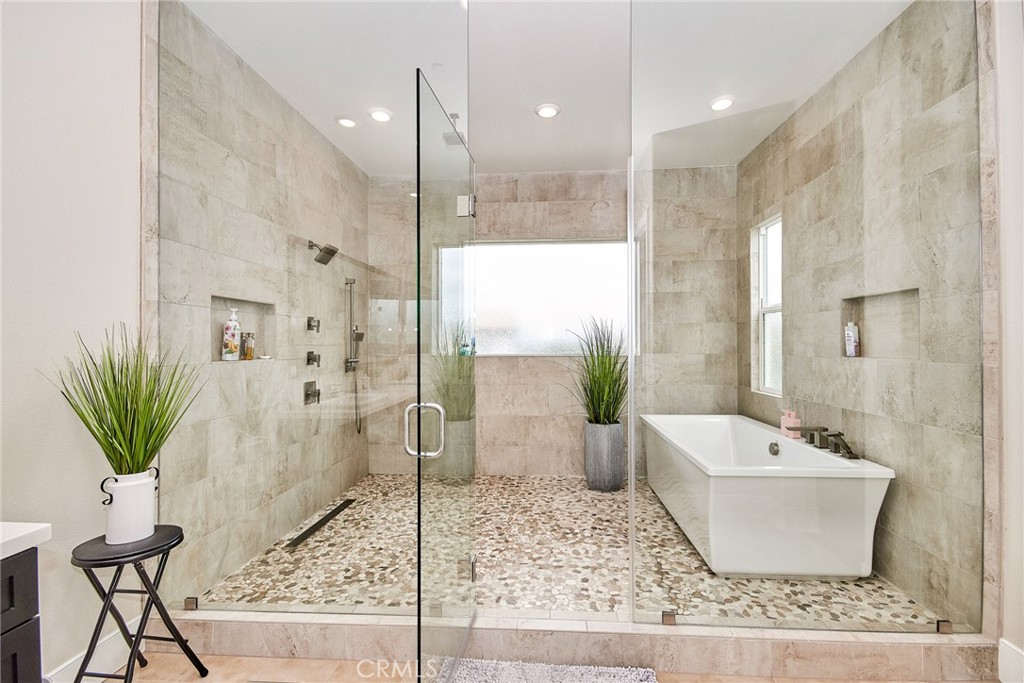 115 Crossover Irvine, CA 92618 - Photo 43 of 64 a bathroom with a bathtub and a shower