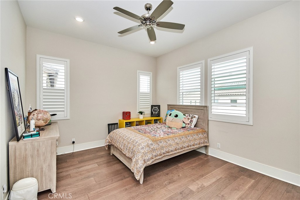 115 Crossover Irvine, CA 92618 - Photo 51 of 64 a bedroom with a bed and a chandelier