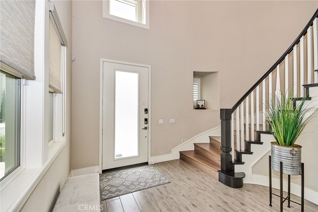 115 Crossover Irvine, CA 92618 - Photo 7 of 64 a view of entryway with wooden floor and stairs