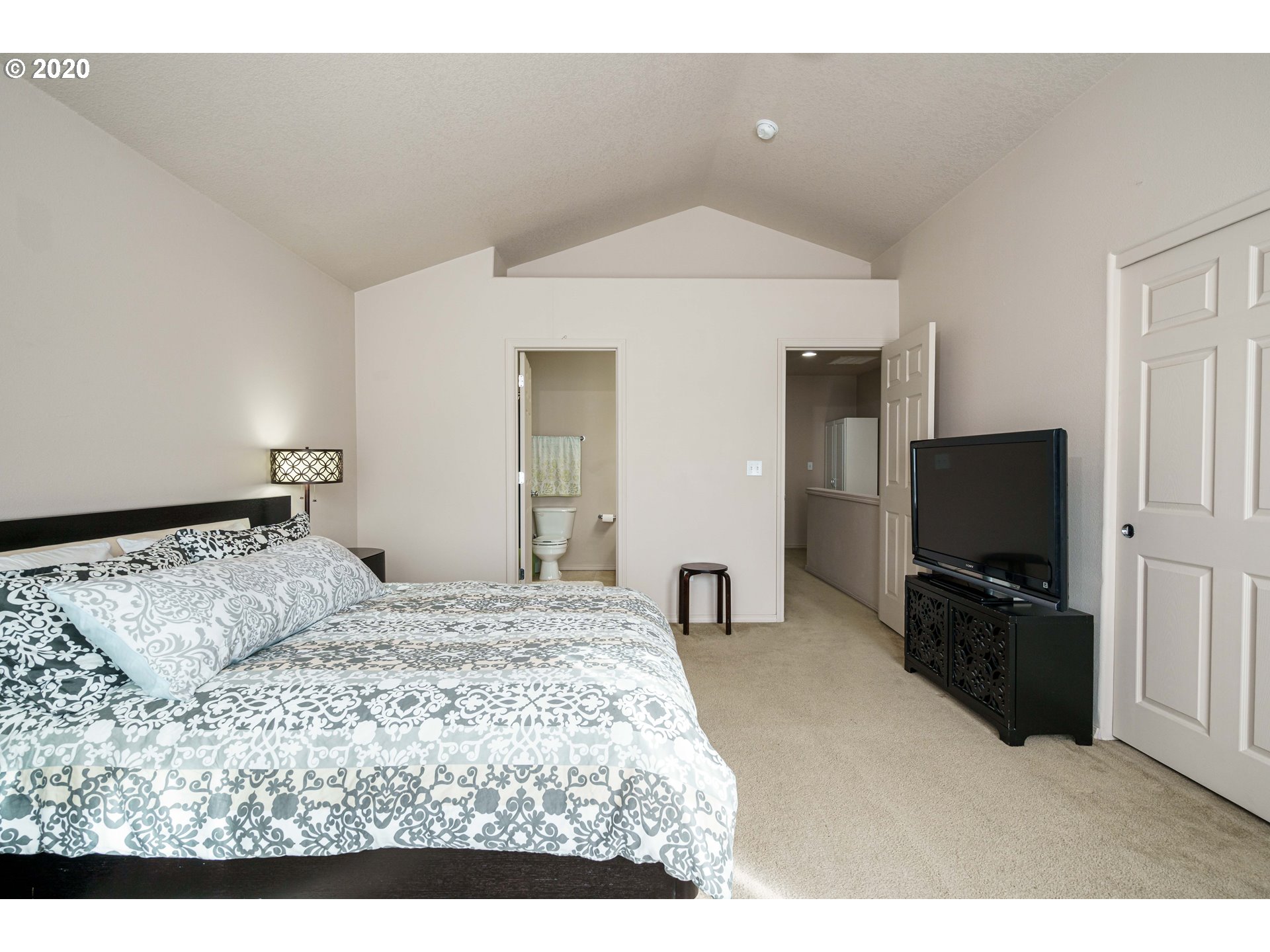 5843 Southeast 16th Loop Gresham, OR 97080 - Photo 17 of 30 a bedroom with a bed and a flat screen tv