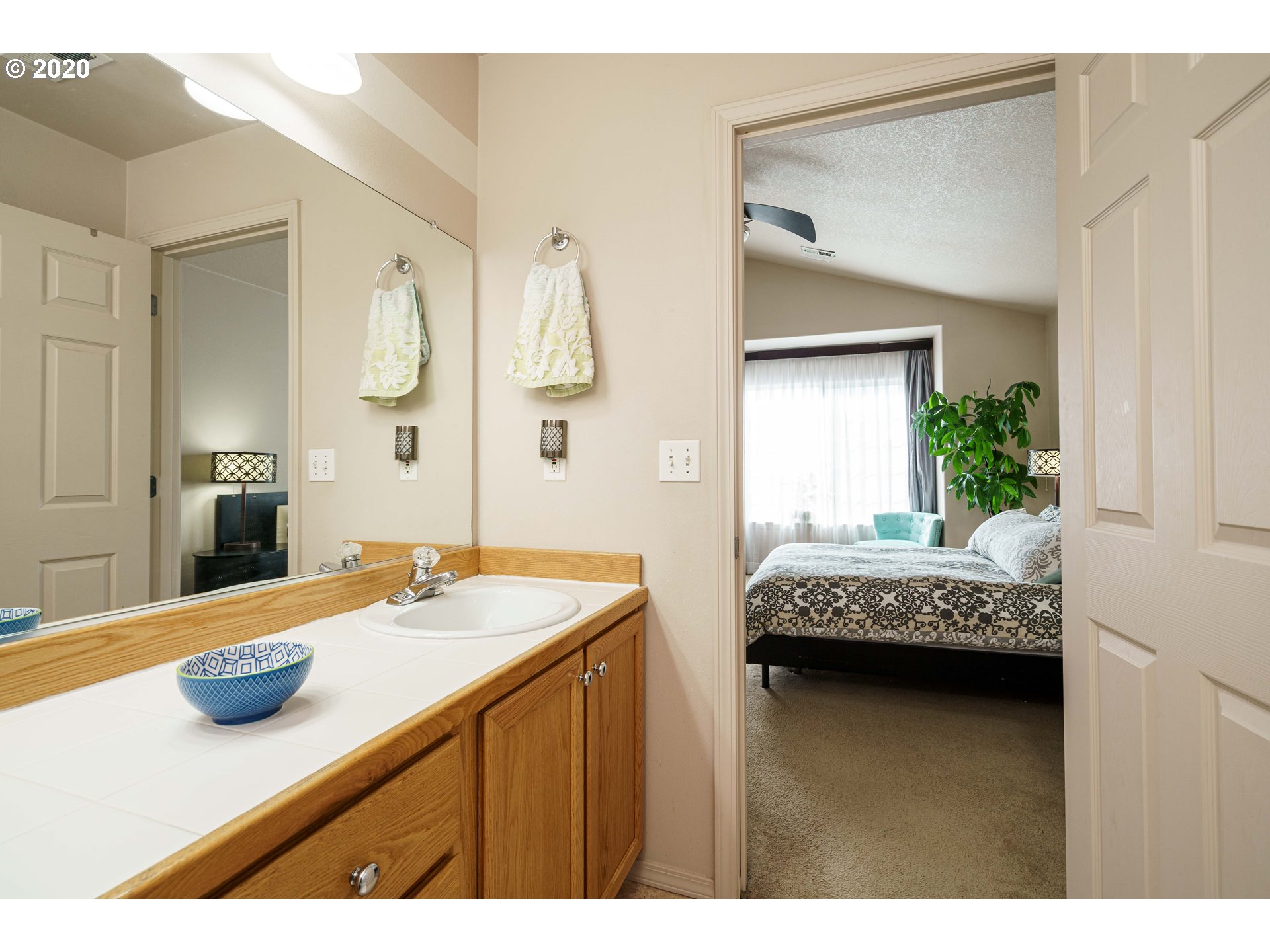 5843 Southeast 16th Loop Gresham, OR 97080 - Photo 18 of 30 a bathroom with a granite countertop sink and a mirror