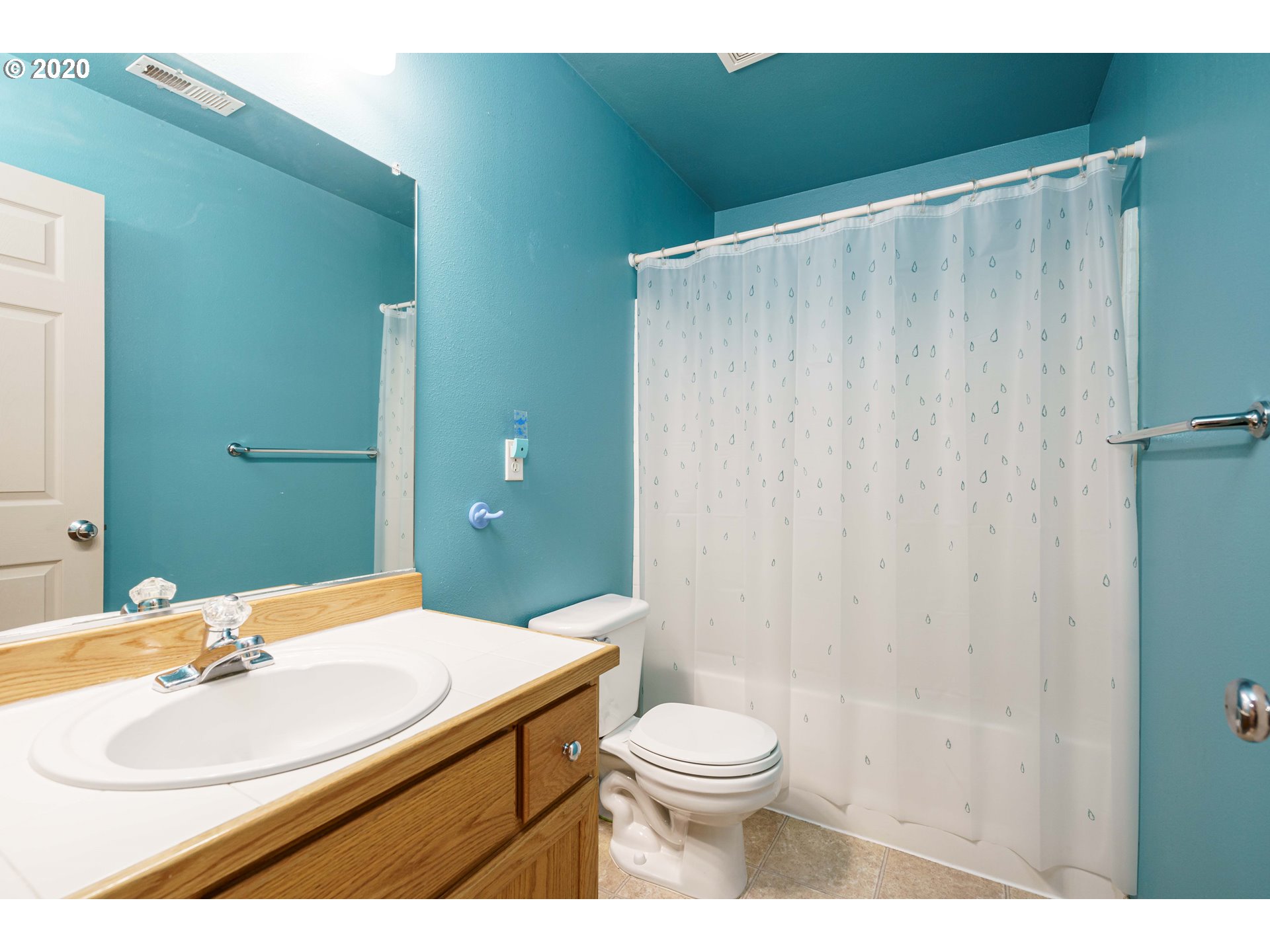 5843 Southeast 16th Loop Gresham, OR 97080 - Photo 22 of 30 a bathroom with a sink a toilet and shower