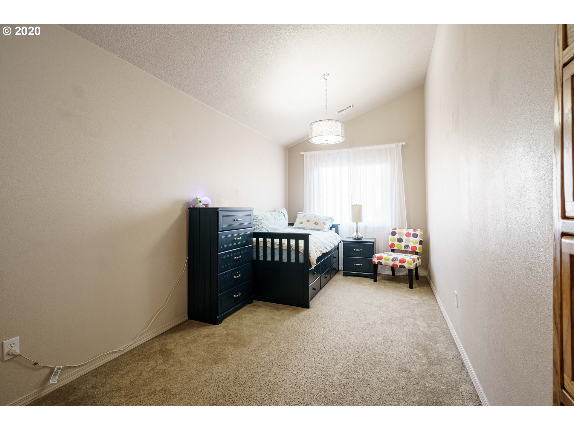 5843 Southeast 16th Loop Gresham, OR 97080 - Photo 23 of 30 a bedroom with furniture and a lamp