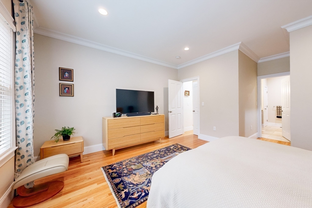 31 Sunset Ridge Lane, Unit 31 Bolton, MA 01740 - Photo 11 of 25 a bedroom with a bed and a flat screen tv