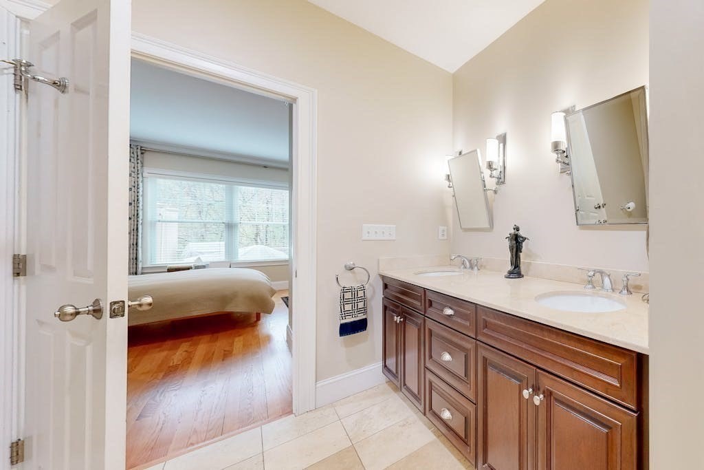 31 Sunset Ridge Lane, Unit 31 Bolton, MA 01740 - Photo 12 of 25 a en suite bathroom with a double vanity sink a mirror and a