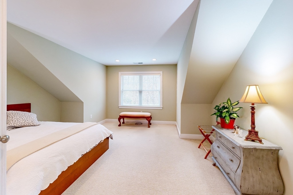 31 Sunset Ridge Lane, Unit 31 Bolton, MA 01740 - Photo 16 of 25 a bedroom with furniture and a potted plant