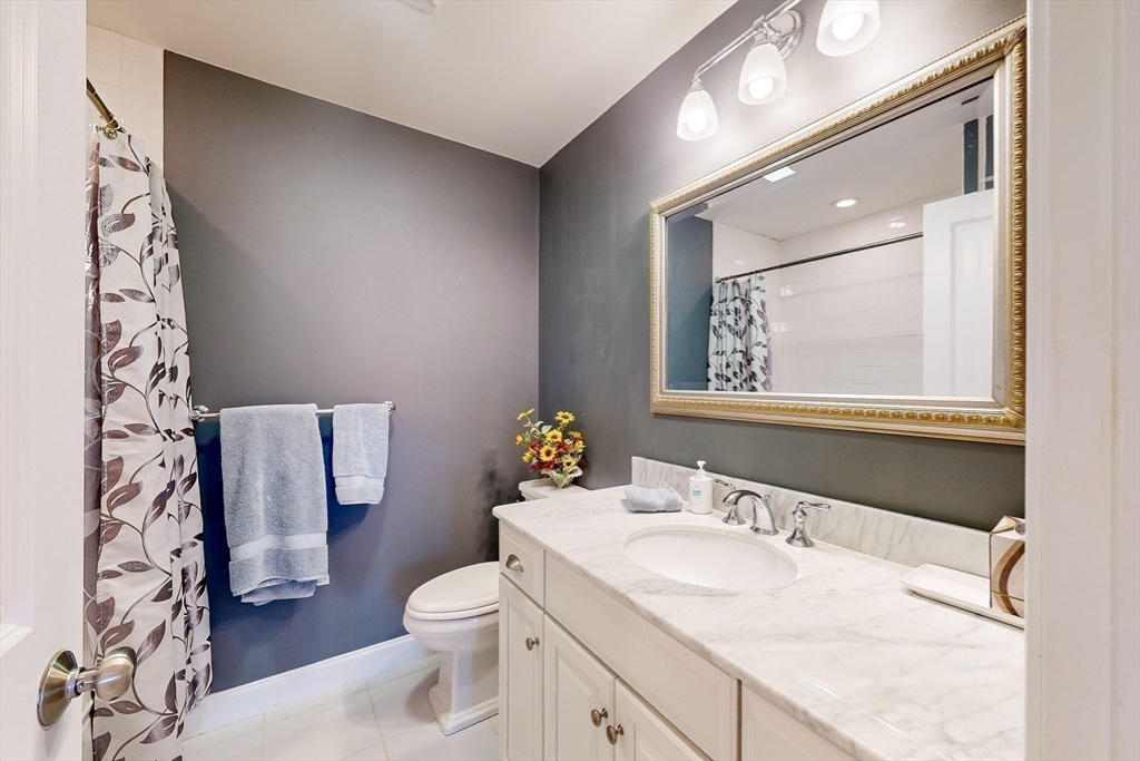 31 Sunset Ridge Lane, Unit 31 Bolton, MA 01740 - Photo 20 of 25 a bathroom with a granite countertop sink toilet and mirror
