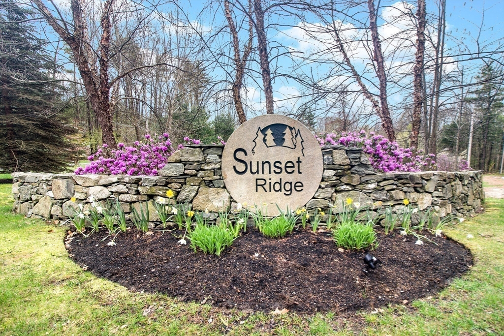 31 Sunset Ridge Lane, Unit 31 Bolton, MA 01740 - Photo 25 of 25 a sign that is sitting in the middle of the forest
