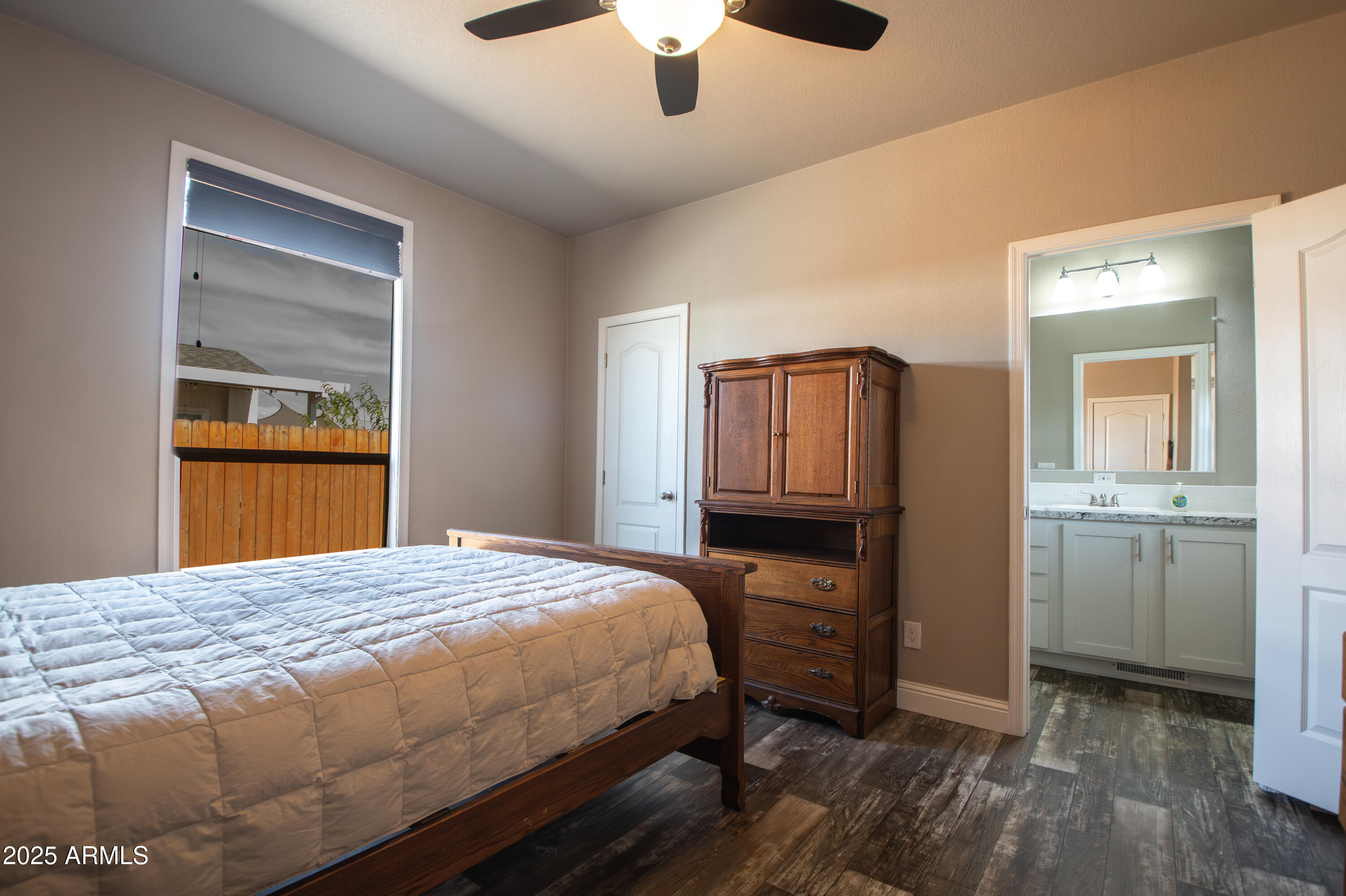1007 Thorton Road Camp Verde, AZ 86322 - Photo 20 of 32 a bedroom with a bed and a chandelier