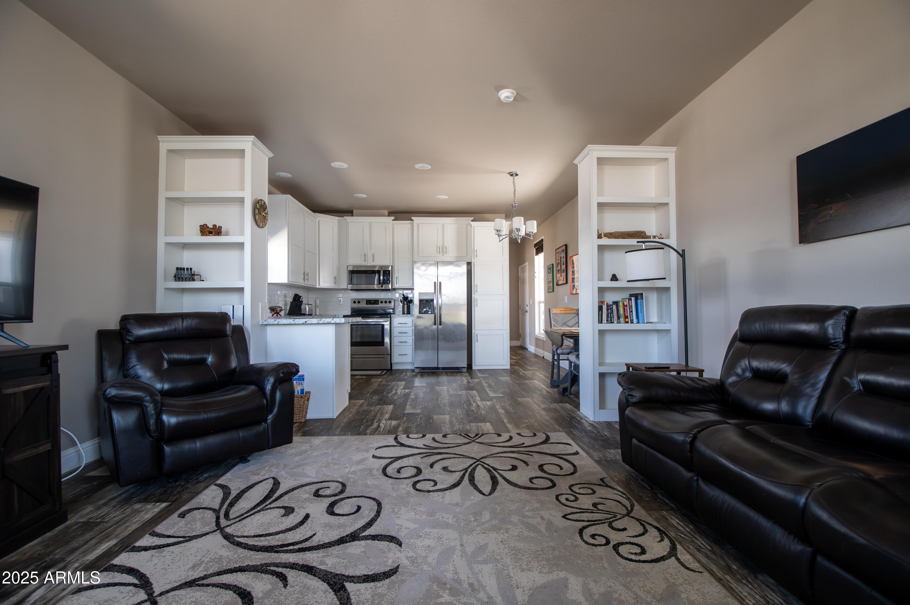 1007 Thorton Road Camp Verde, AZ 86322 - Photo 7 of 32 a living room with furniture a flat screen tv and kitchen view