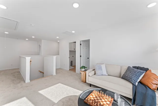 a living room with furniture and a potted plant