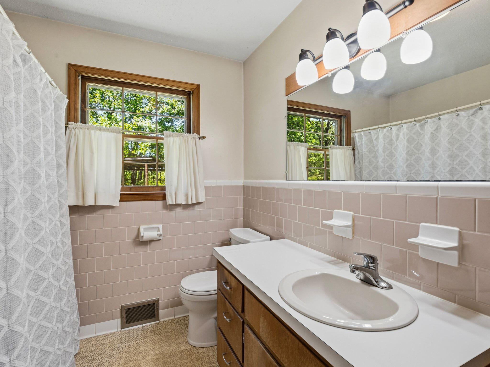 1115 Robin Ridge Road Henry, VA 24102 - Photo 22 of 54 a bathroom with a sink a toilet and mirror