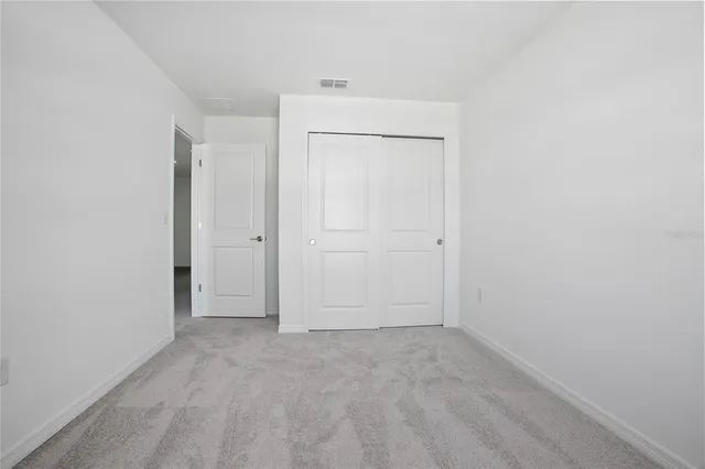 an empty room with closet area