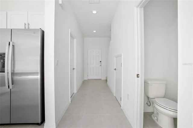 a bathroom with a granite countertop toilet and a shower