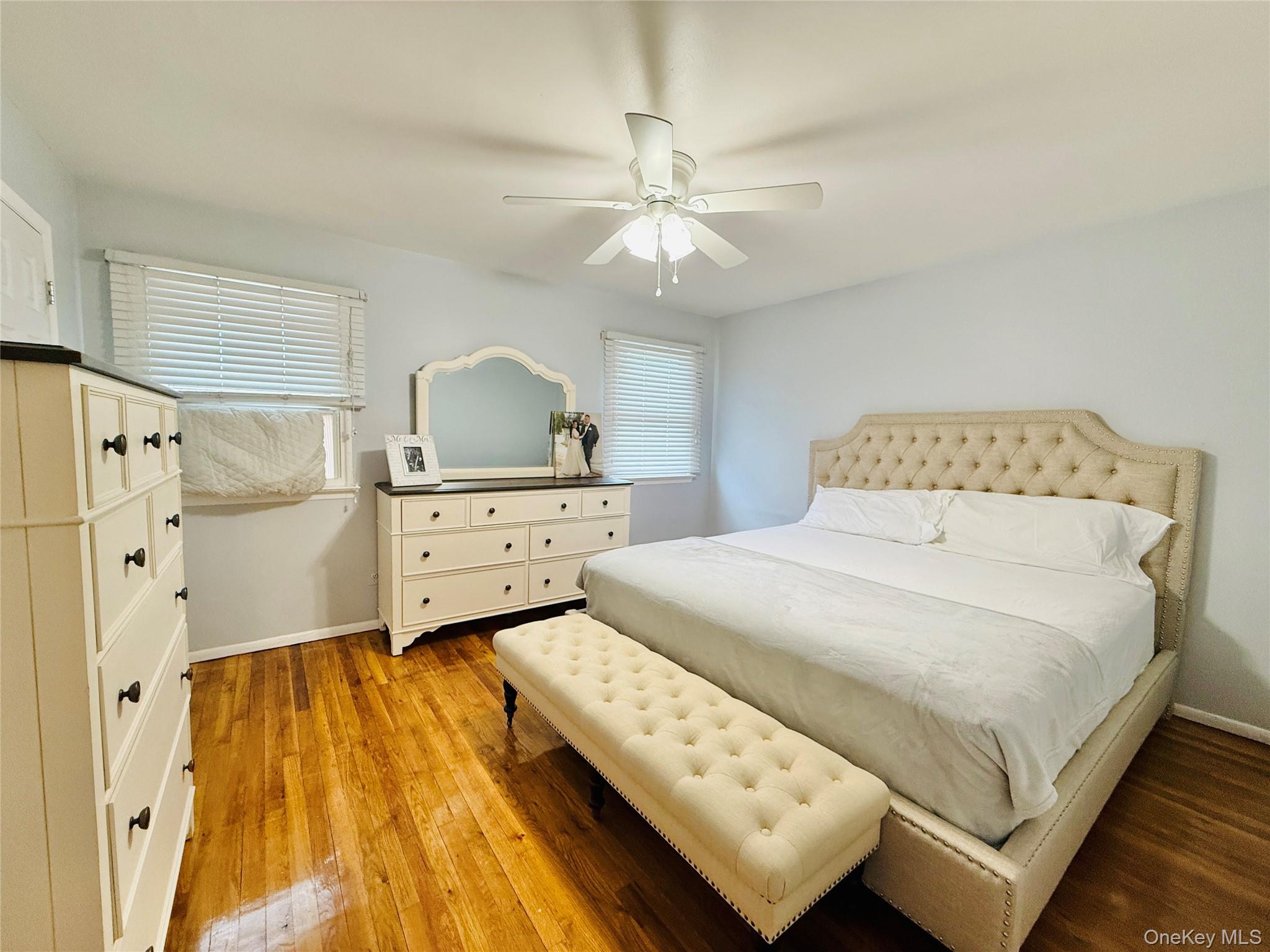 1663 Waring Avenue Bronx, NY 10469 - Photo 13 of 34 a bedroom with a bed and a chandelier