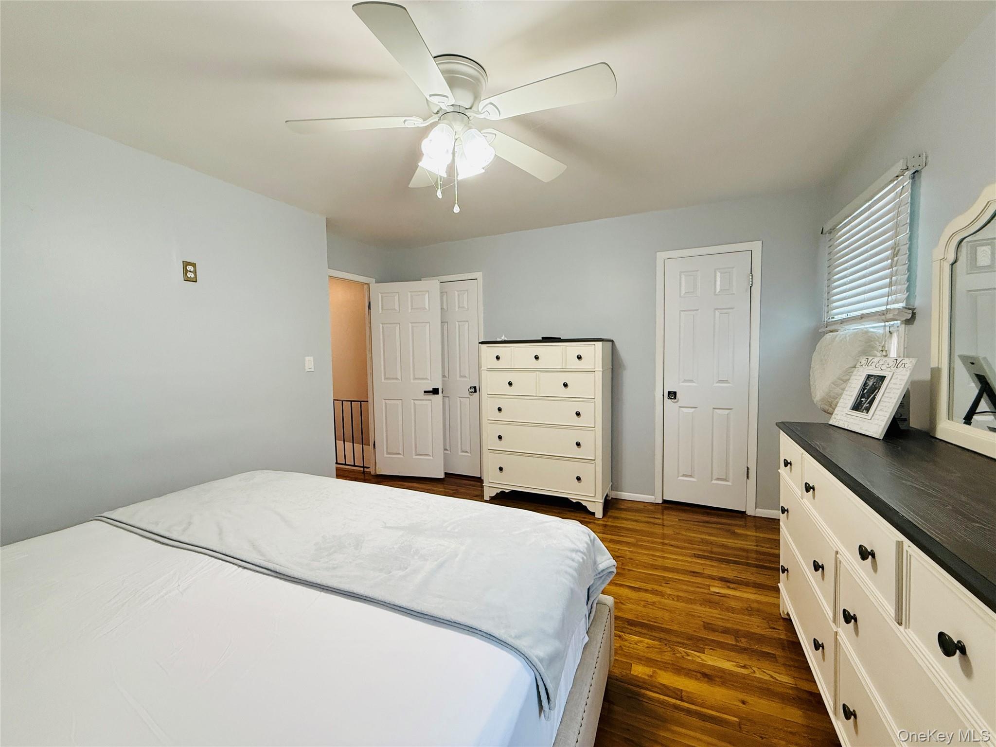 1663 Waring Avenue Bronx, NY 10469 - Photo 14 of 34 a spacious bedroom with a bed and a chandelier