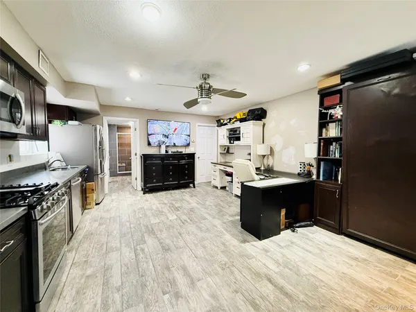 a large kitchen with stainless steel appliances granite countertop a lot of counter space and a sink