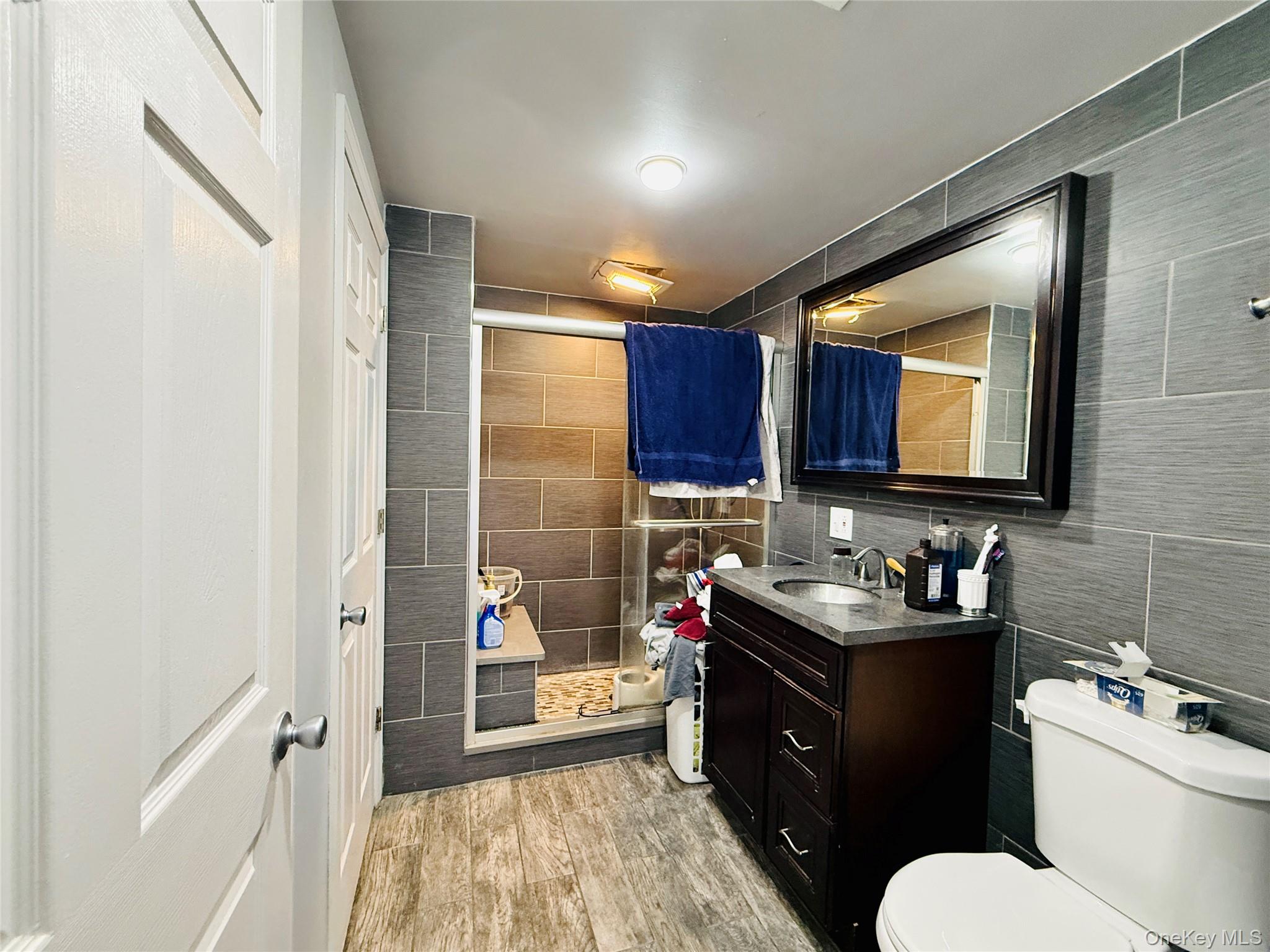1663 Waring Avenue Bronx, NY 10469 - Photo 26 of 34 a bathroom with a toilet sink vanity granite and mirror
