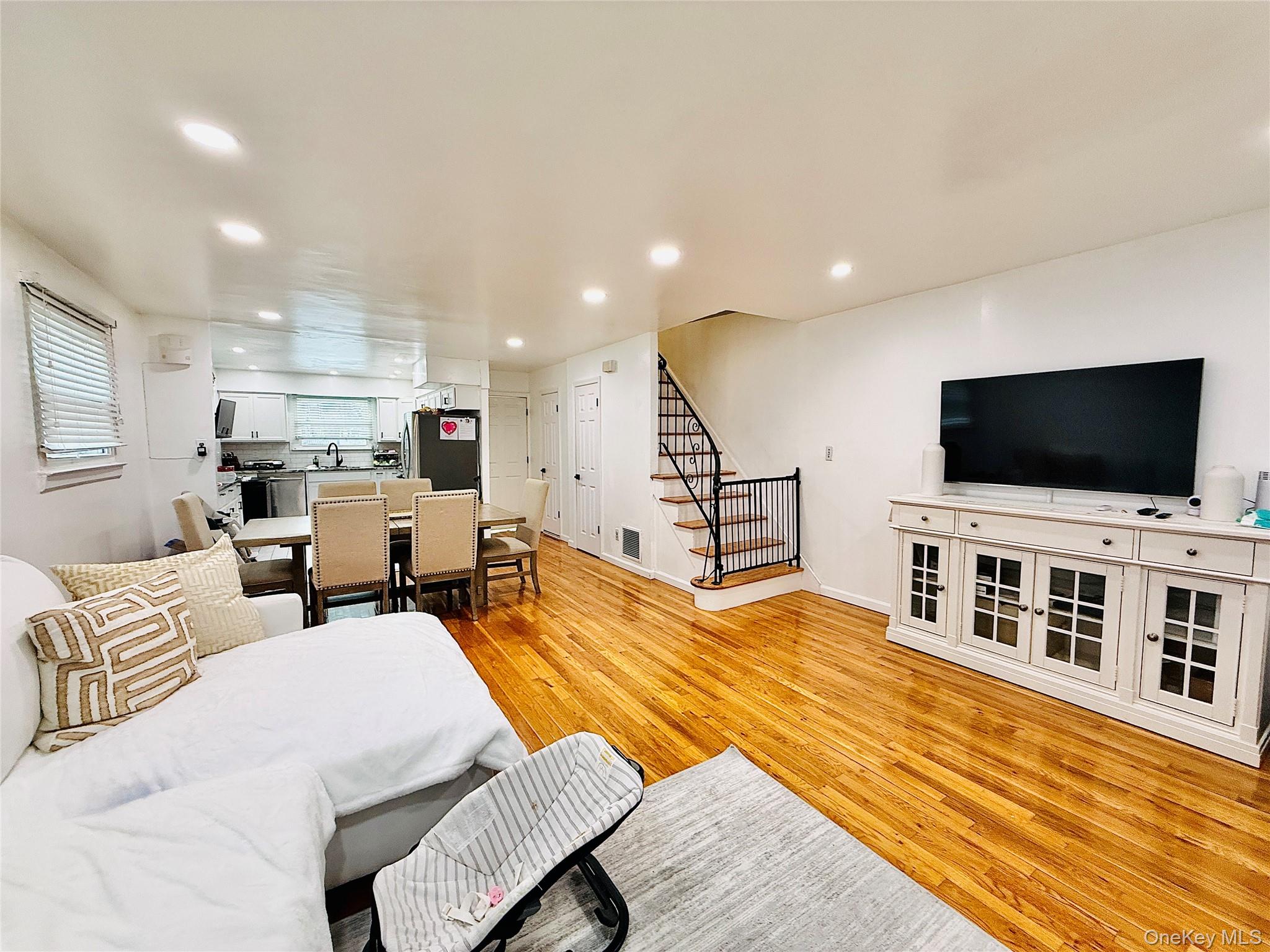 1663 Waring Avenue Bronx, NY 10469 - Photo 3 of 34 a living room with furniture and a flat screen tv