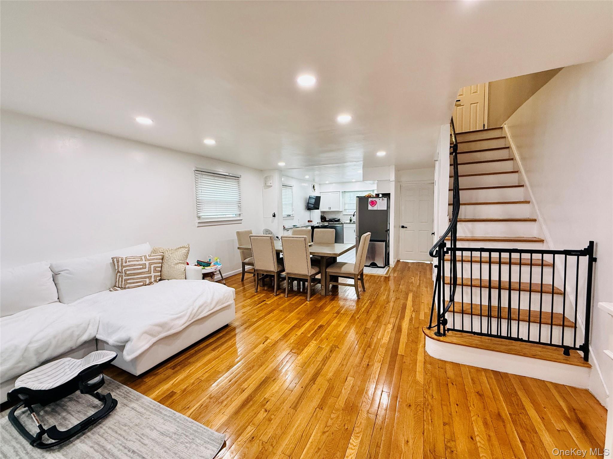 1663 Waring Avenue Bronx, NY 10469 - Photo 4 of 34 a living room with furniture and a wooden floor