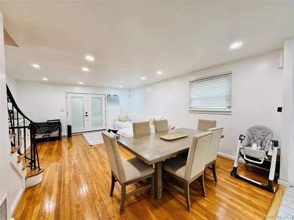 a dining room with furniture and wooden floor