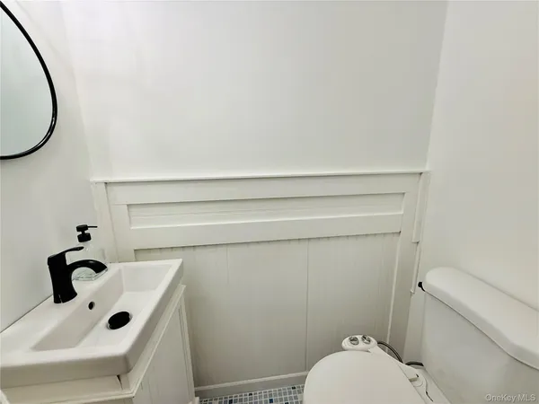 a view of a bedroom with wooden floor and staircase