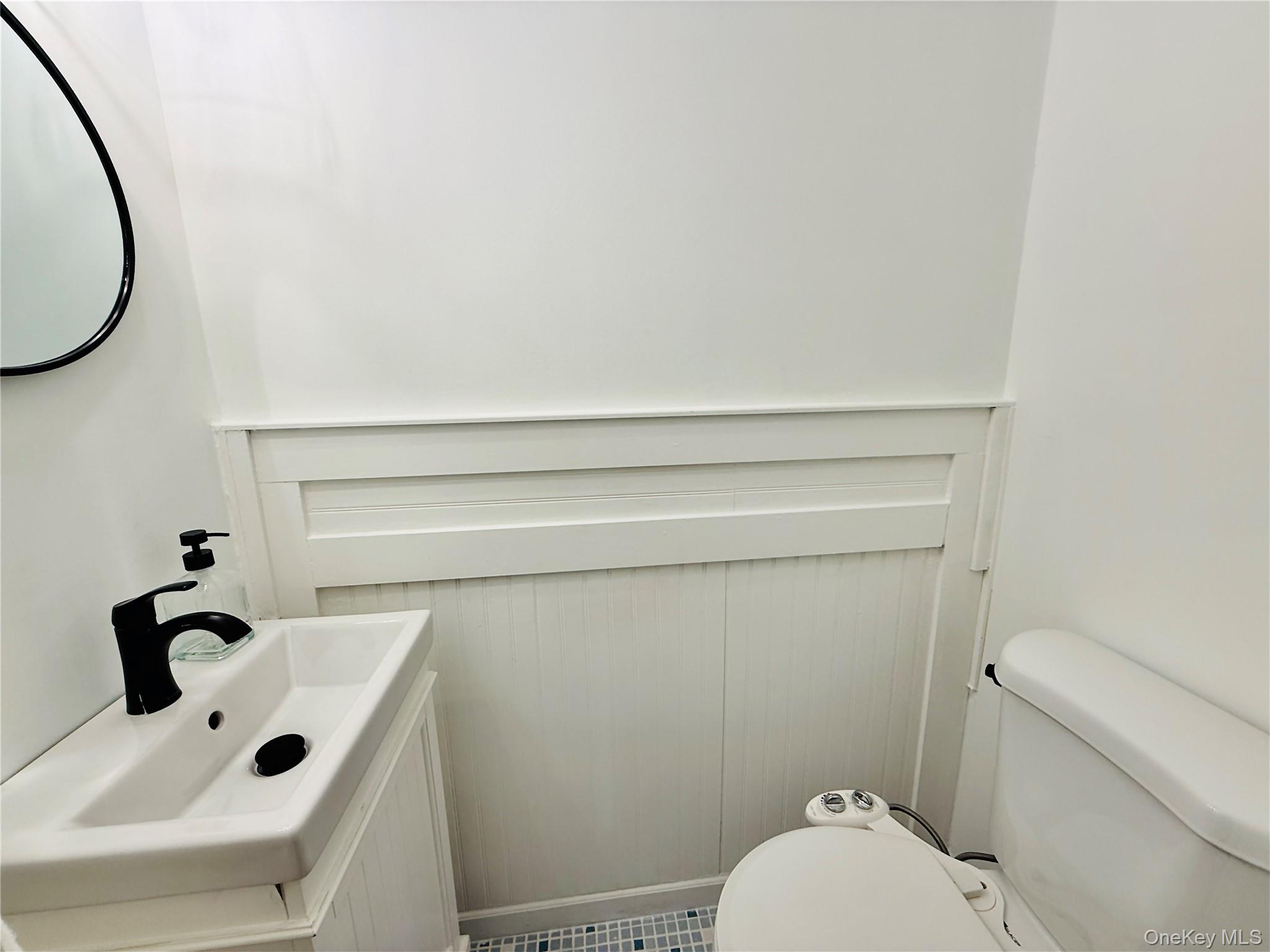 1663 Waring Avenue Bronx, NY 10469 - Photo 9 of 34 a bathroom with a sink and a toilet