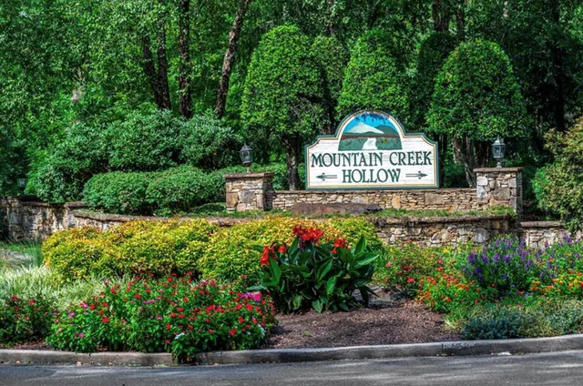 a view of a sign in front of flowers