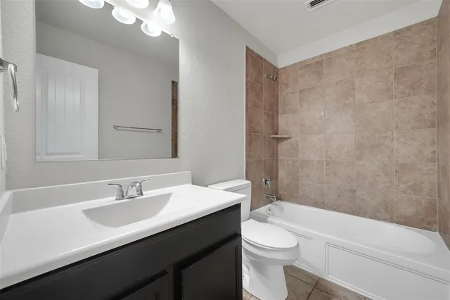 a bathroom with a sink a toilet a shower and a mirror