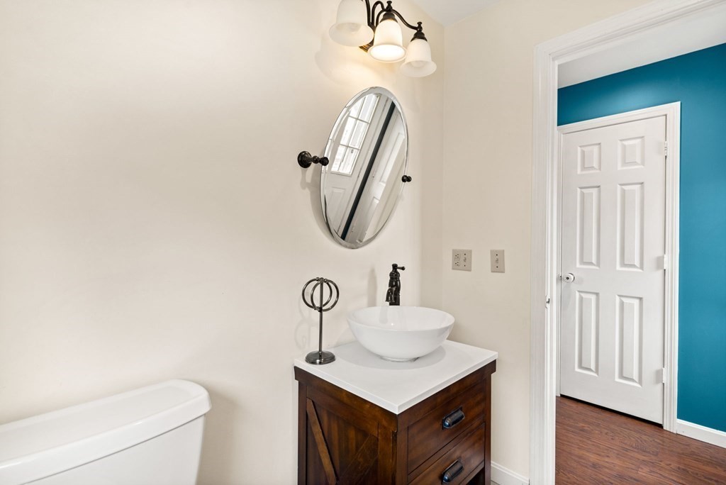 72 Beach Road Salisbury, MA 01952 - Photo 18 of 37 a bathroom with a sink a toilet and a mirror