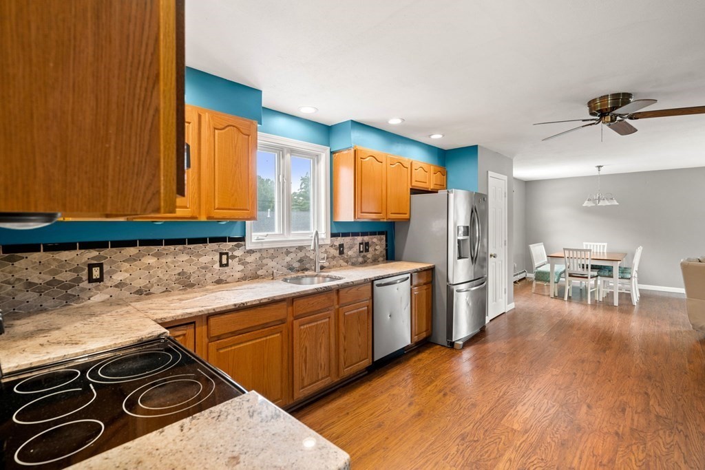 72 Beach Road Salisbury, MA 01952 - Photo 8 of 37 a kitchen with stainless steel appliances granite countertop a sink stove and refrigerator