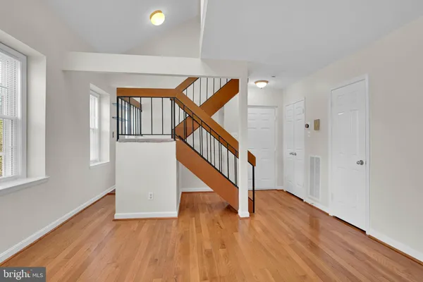 a view of entryway and hall with wooden floor