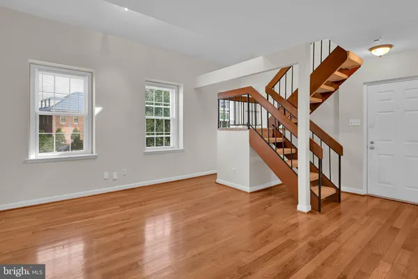 a view of an entryway with wooden floor and stairs
