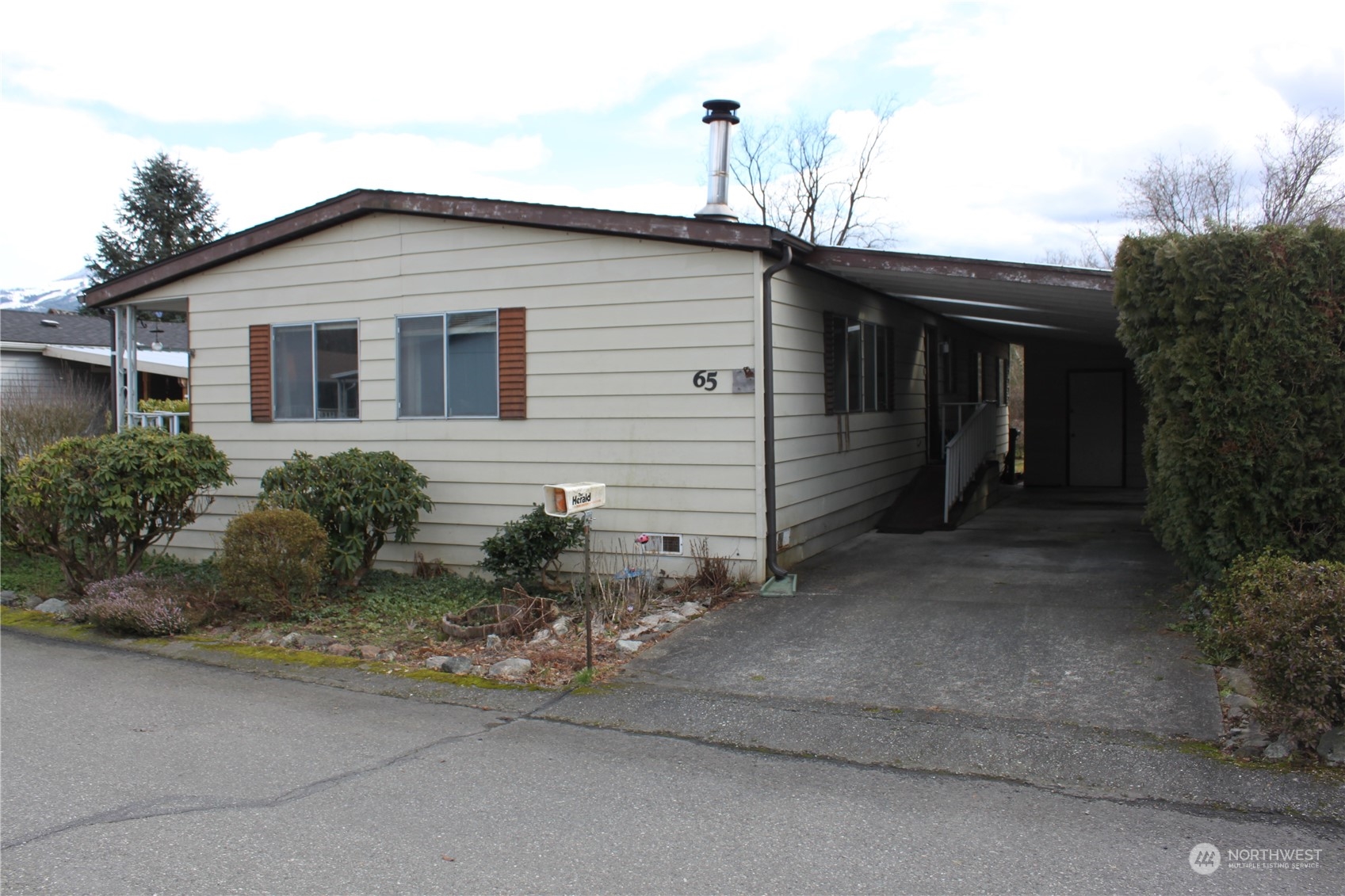 212 Old Owen Road, Unit 65 Sultan, WA 98294 - Photo 3 of 12 a front view of a house with a yard
