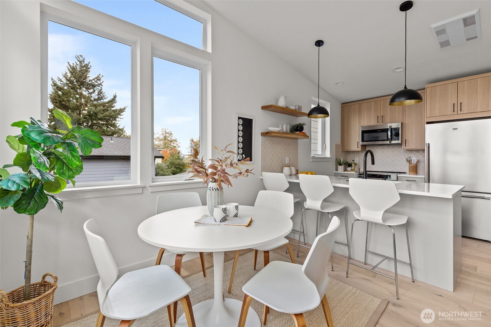 8407 42nd Avenue Southwest Seattle, WA 98136 - Photo 12 of 34 a kitchen with a table and chairs