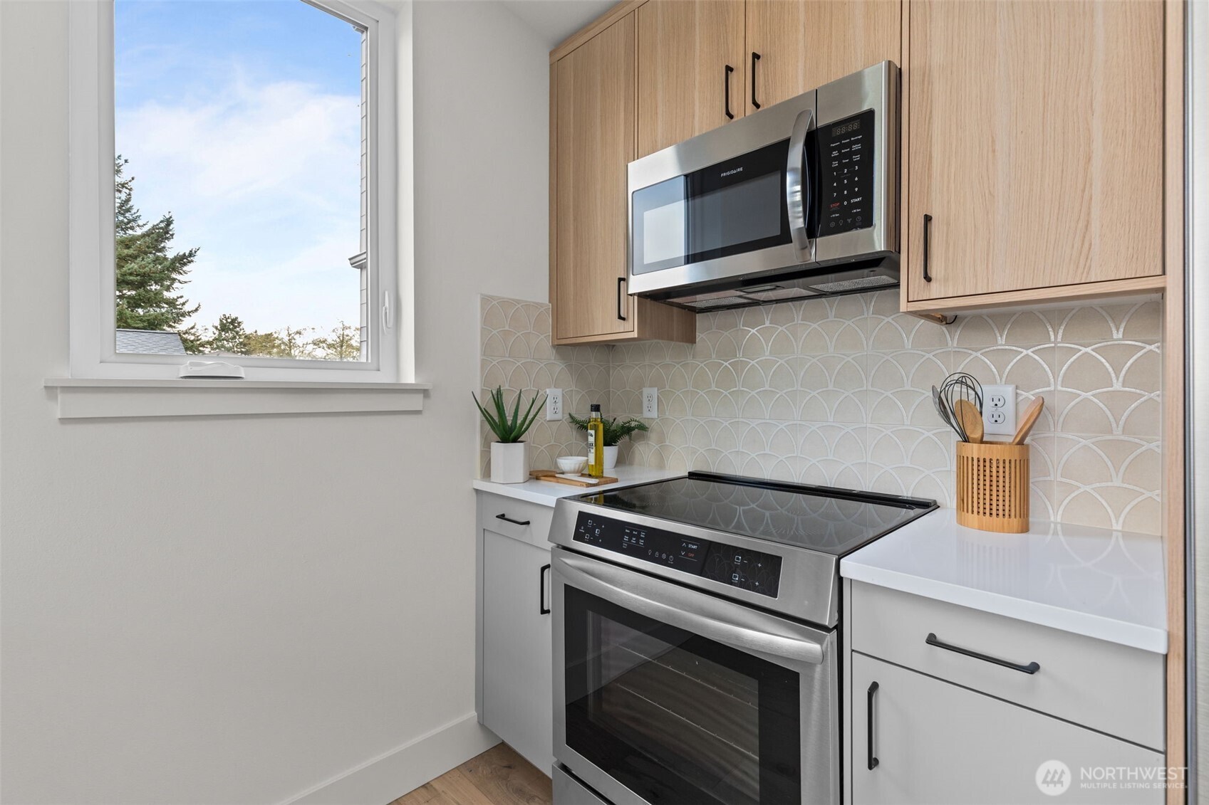 8407 42nd Avenue Southwest Seattle, WA 98136 - Photo 14 of 34 a kitchen with stainless steel appliances granite countertop white cabinets a microwave oven and a stove