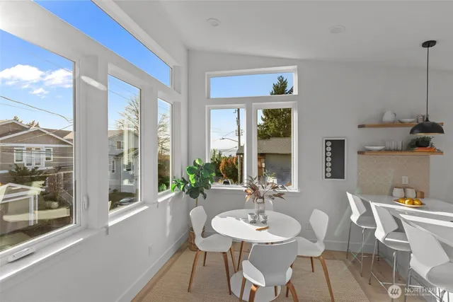a view of a dining room with furniture window and wooden floor