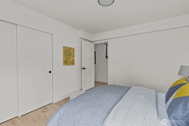 a bedroom with a bed and painting on the wall