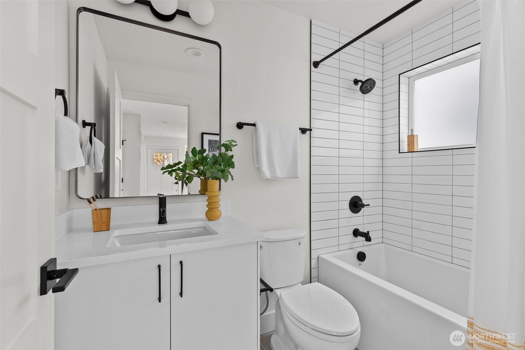 8407 42nd Avenue Southwest Seattle, WA 98136 - Photo 28 of 34 a bathroom with a sink a toilet a mirror and shower