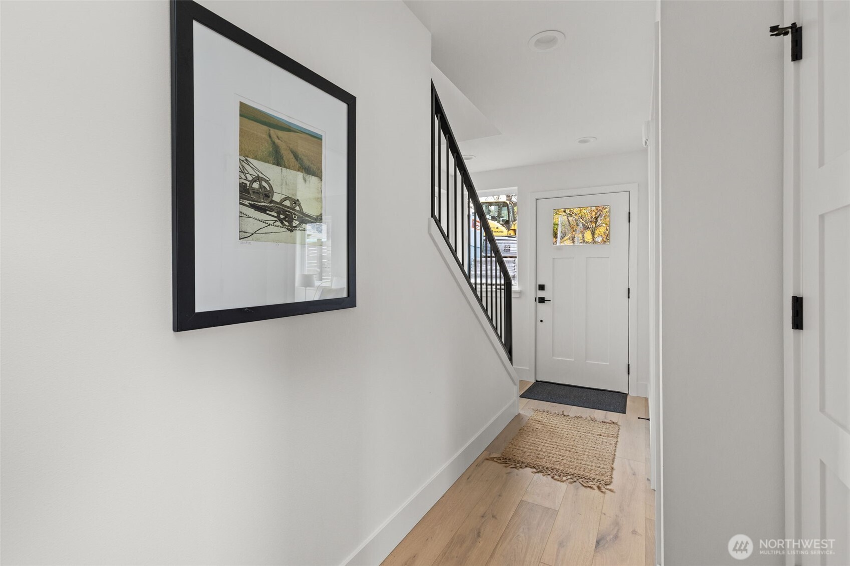8407 42nd Avenue Southwest Seattle, WA 98136 - Photo 30 of 34 a view of a hallway with wooden floor and stairs