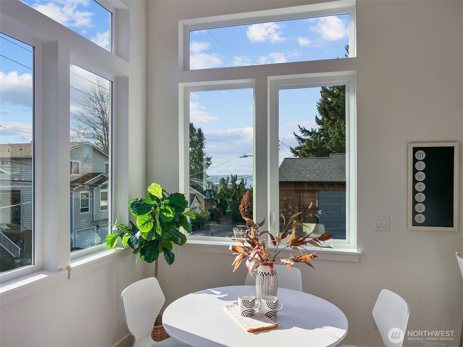 8407 42nd Avenue Southwest Seattle, WA 98136 - Photo 3 of 34 a dining room with furniture a potted plant and a mirror