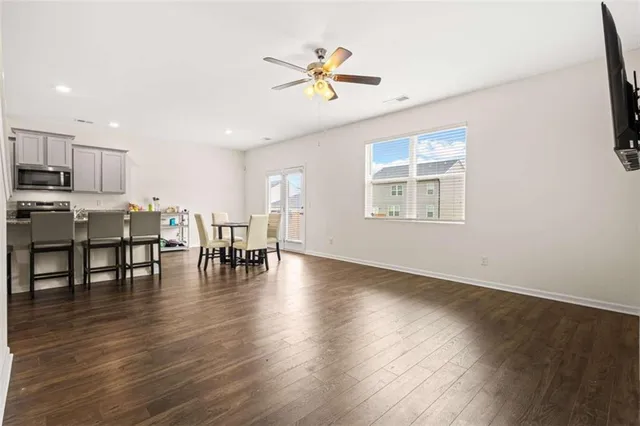 a view of a work space with furniture and wooden floor
