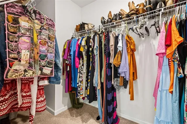 a view of walk in closet with clothes