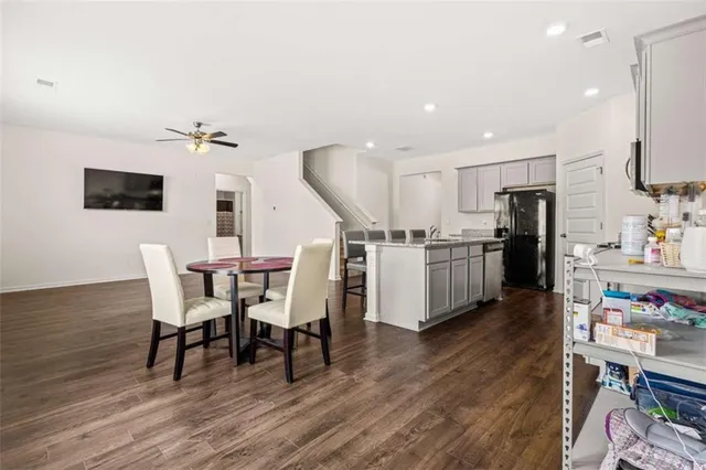 a living room with lots of furniture and kitchen view