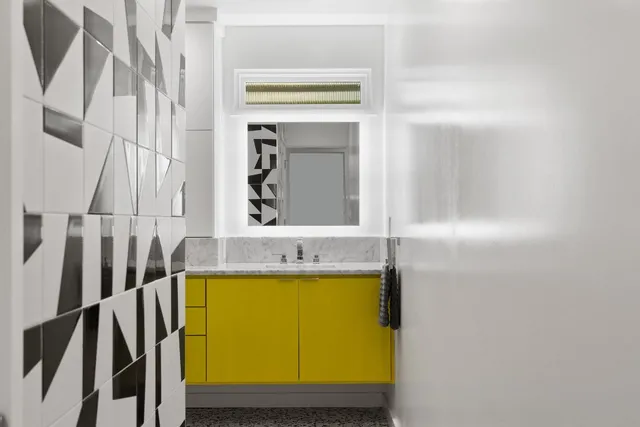 a bathroom with a bathtub sink and mirror